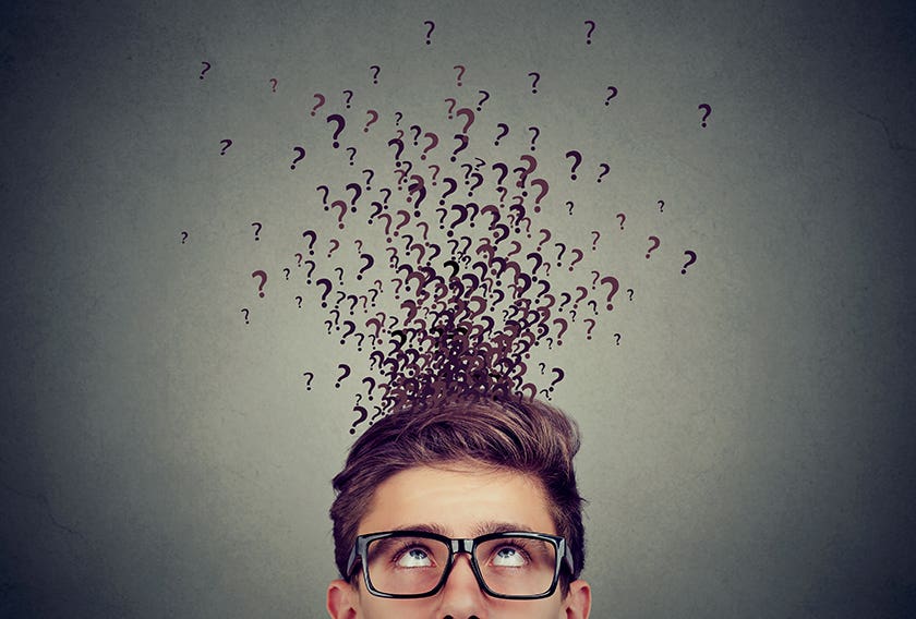 Man with question marks above head