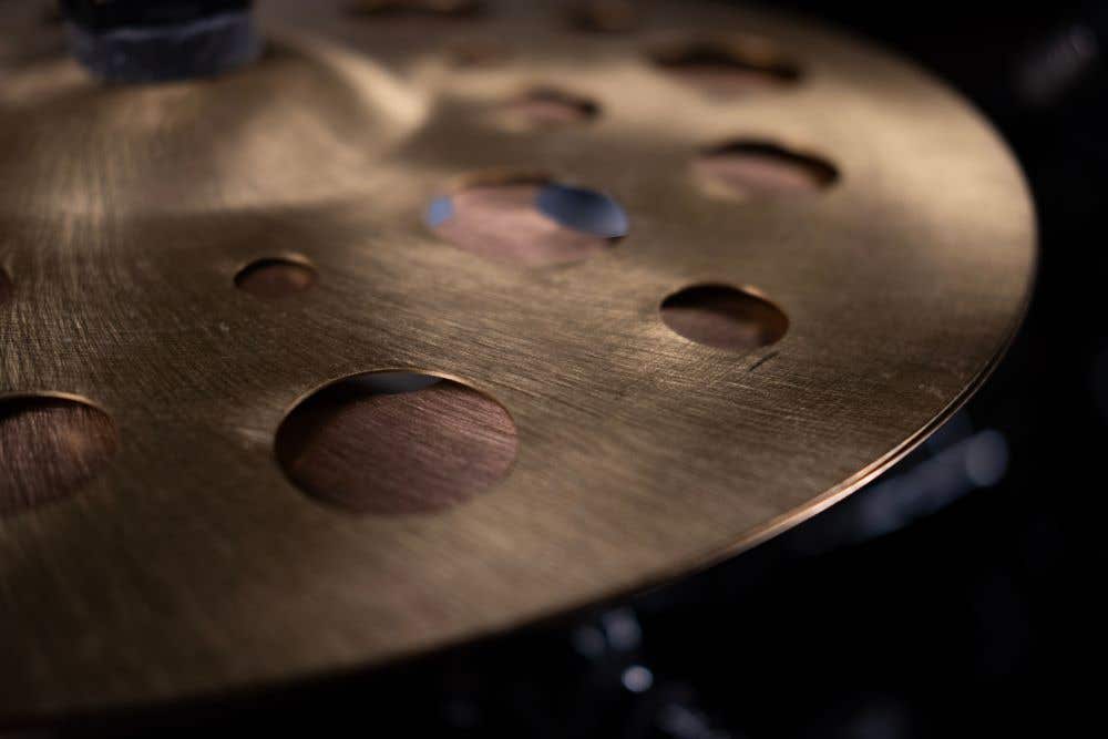 Specialty cymbal with holes
